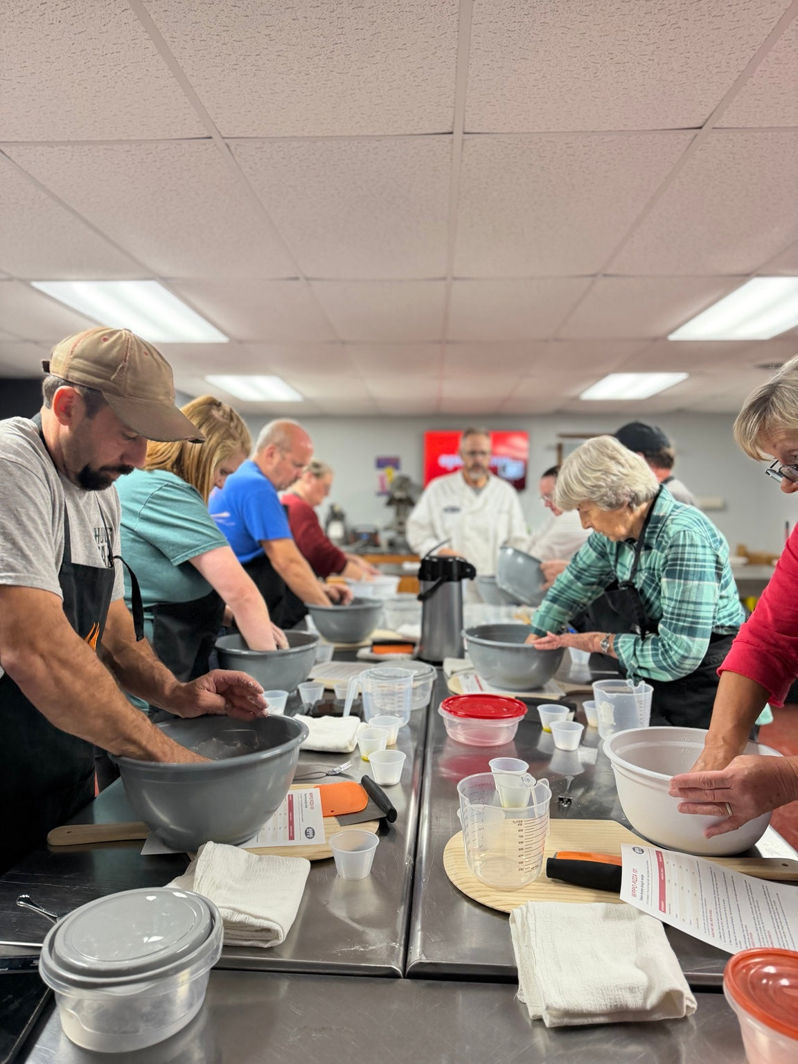 Students making pizza dough during a WPPO Pizza 101 hands-on class